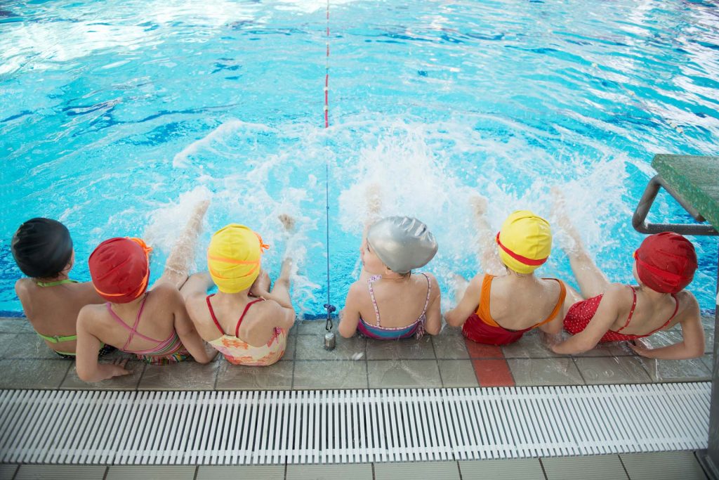 School children at the swimming pool for a swimming lesson.